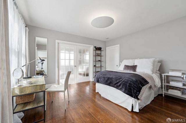 bedroom with french doors and wood finished floors