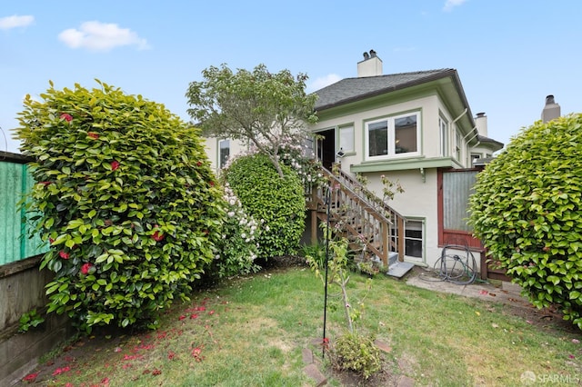 135 San Rafael Way, San Francisco, CA 94127 - back of property with stairway, stucco siding, a lawn, and a chimney