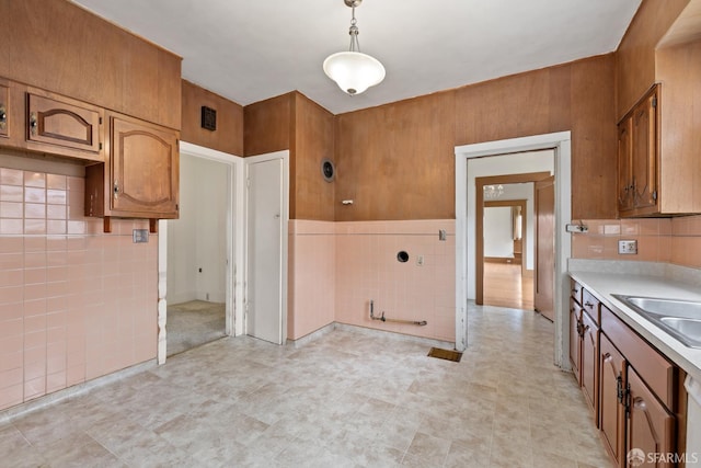 135 San Rafael Way, San Francisco, CA 94127 - kitchen featuring tile walls, light countertops, brown cabinets, decorative light fixtures, and a sink