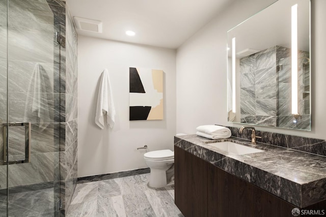 bathroom featuring an enclosed shower, vanity, and toilet