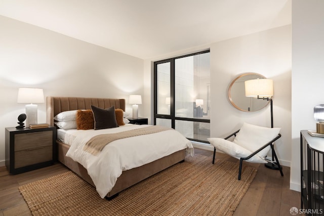 bedroom with dark hardwood / wood-style flooring