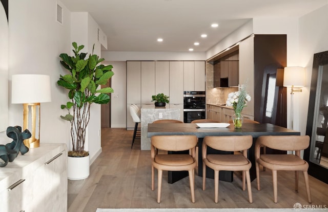 dining room with light hardwood / wood-style floors