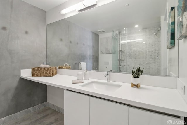 full bath with a stall shower, visible vents, and vanity