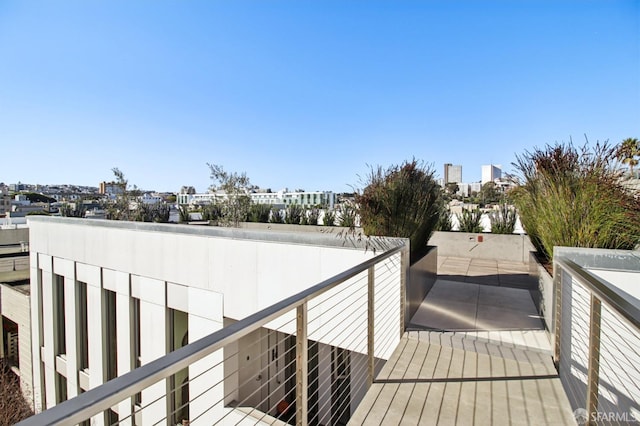 wooden terrace featuring a city view