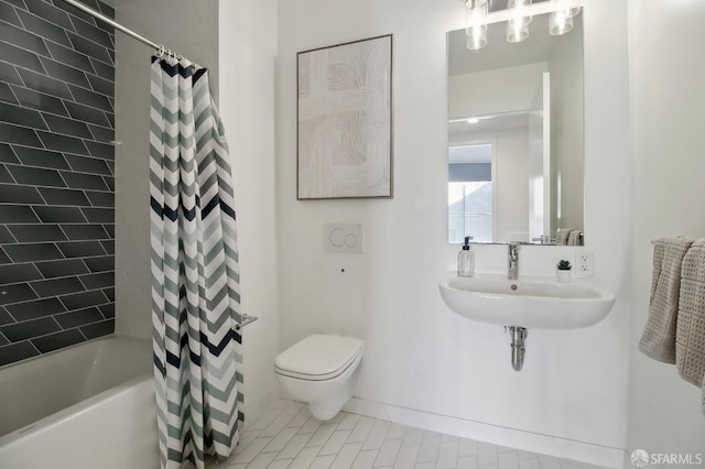 bathroom featuring shower / tub combo, a sink, and toilet