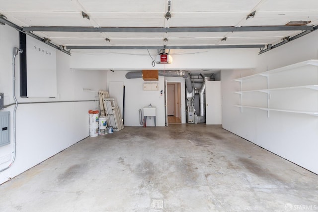garage with a garage door opener, heating unit, and a sink