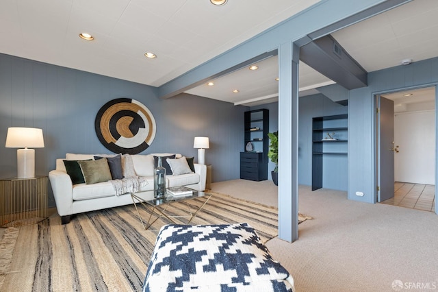 living area with beam ceiling, visible vents, recessed lighting, and carpet flooring