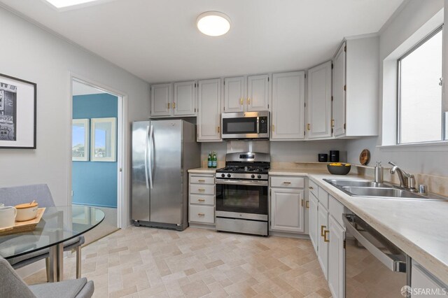 kitchen featuring a sink, appliances with stainless steel finishes, and light countertops