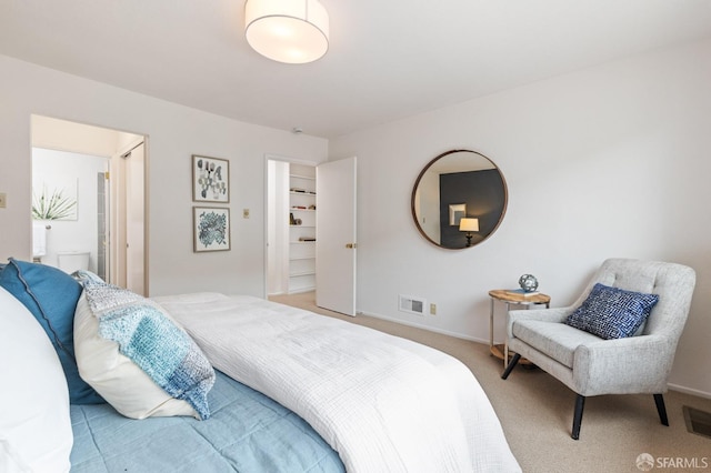 carpeted bedroom featuring visible vents and baseboards