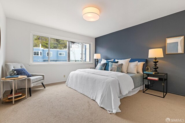 carpeted bedroom featuring baseboards
