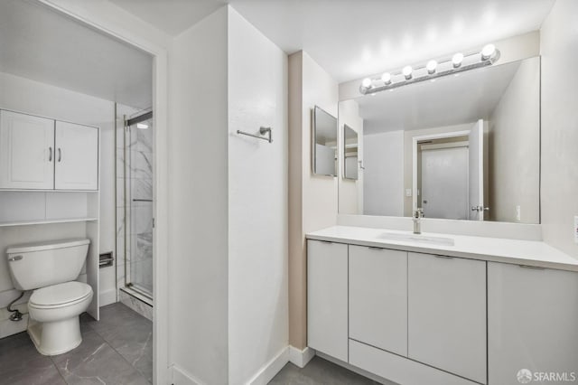 bathroom with vanity, toilet, and a shower with shower door