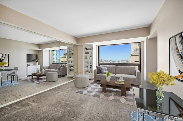 living room featuring carpet flooring, a healthy amount of sunlight, and built in features