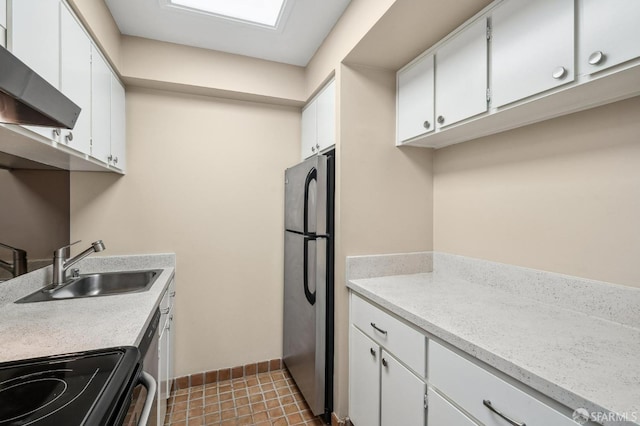 kitchen with stainless steel refrigerator, white cabinetry, sink, range hood, and stove