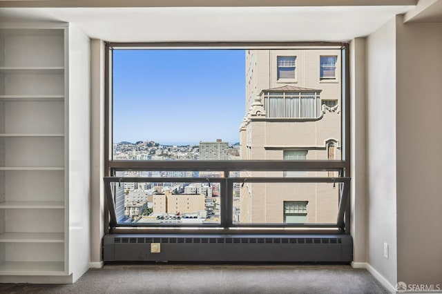 interior details featuring radiator heating unit and carpet floors