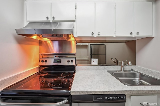 kitchen featuring white cabinetry, sink, exhaust hood, and appliances with stainless steel finishes