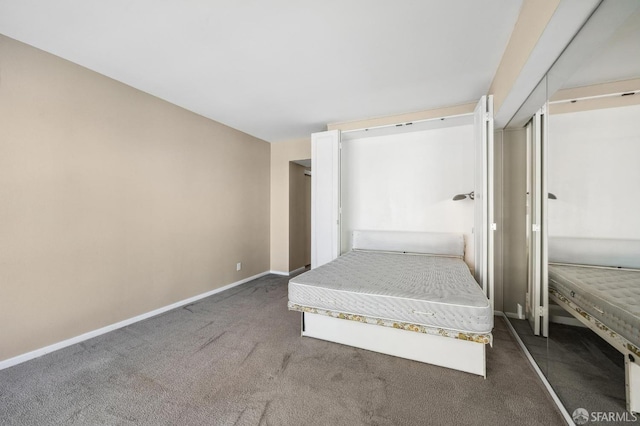 unfurnished bedroom with dark carpet