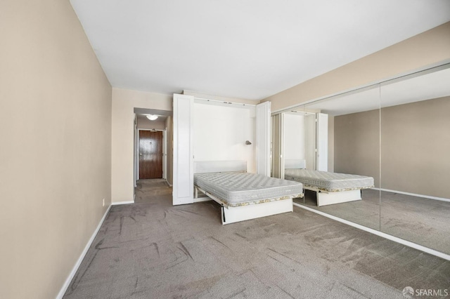 unfurnished bedroom featuring carpet floors and a closet