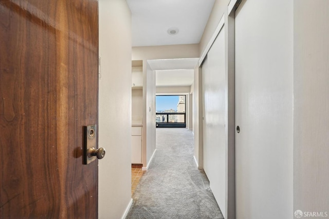 corridor with light colored carpet