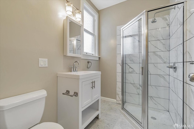 bathroom with vanity, toilet, and a shower with door