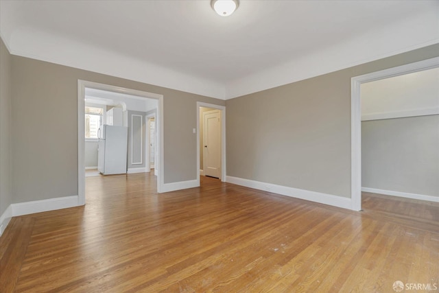 spare room with light hardwood / wood-style flooring