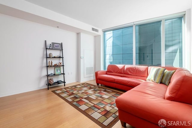 living room with wood-type flooring and expansive windows