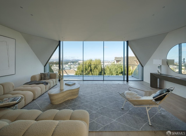 living room with hardwood / wood-style floors and a wall of windows