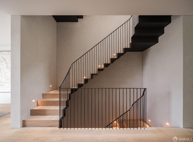 staircase featuring hardwood / wood-style flooring