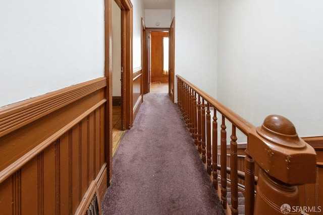 corridor featuring dark carpet