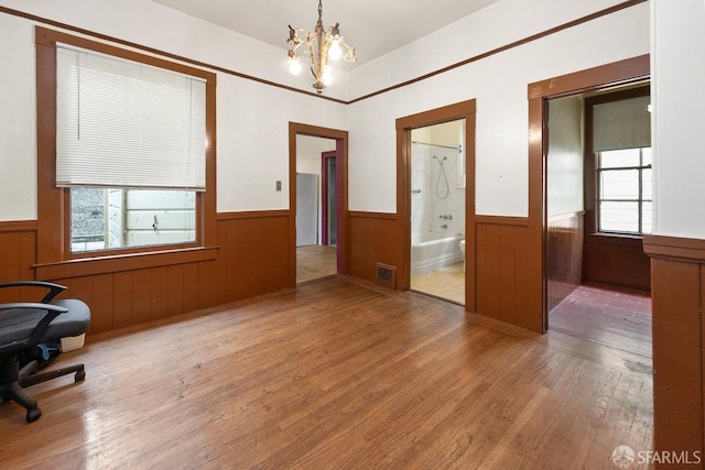 interior space with hardwood / wood-style flooring and a chandelier