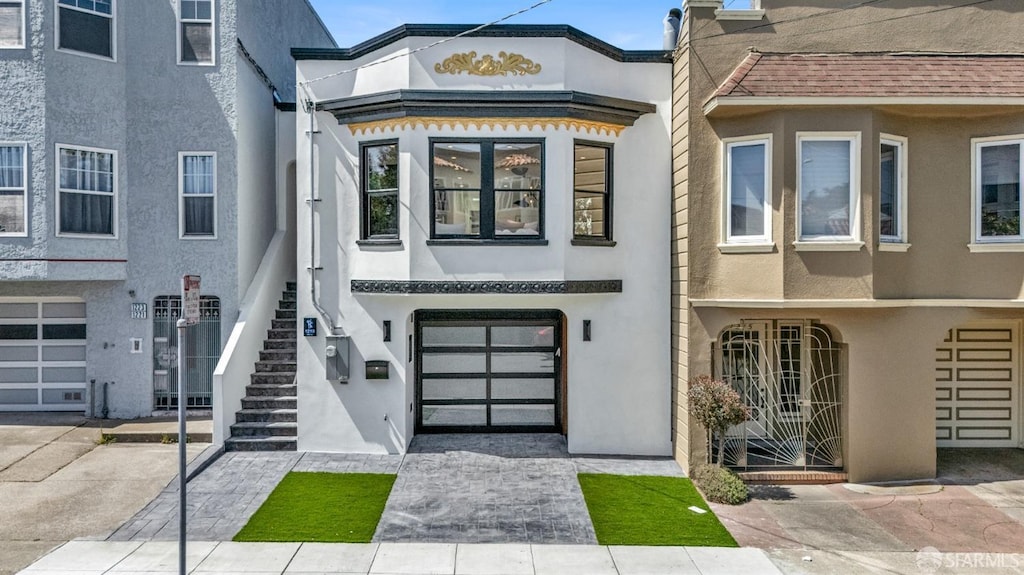 view of property with stairway and stucco siding
