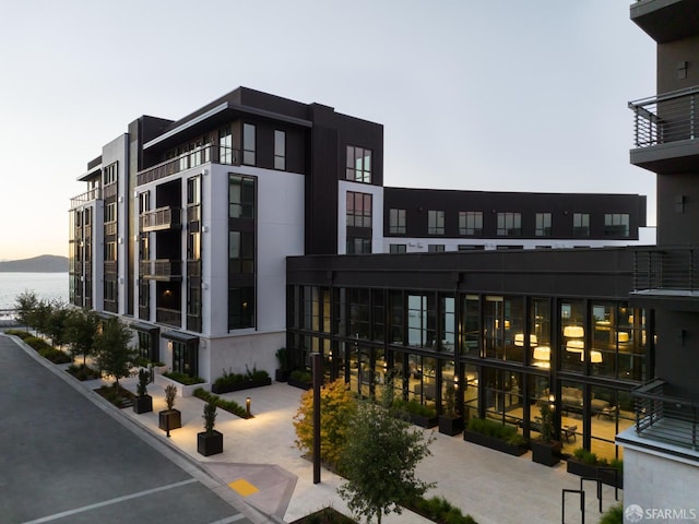 outdoor building at dusk featuring a water view