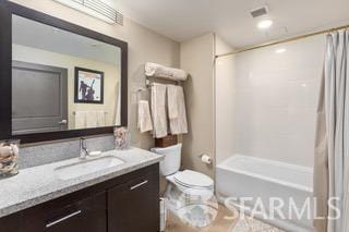 full bath featuring toilet, visible vents, shower / bath combination with curtain, and vanity