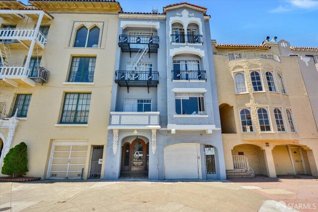 3675 Fillmore St Unit 102, San Francisco, CA 94123 - view of apartment building / complex featuring an attached garage and concrete driveway