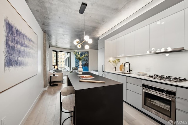 kitchen featuring a kitchen island, white cabinetry, and stainless steel appliances