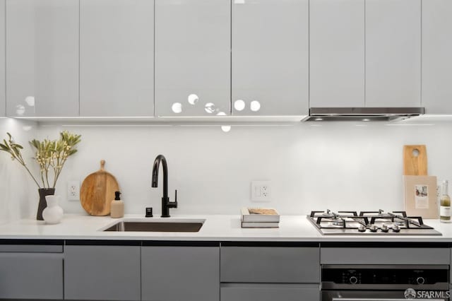 kitchen with gray cabinetry, white cabinetry, sink, oven, and stainless steel gas stovetop