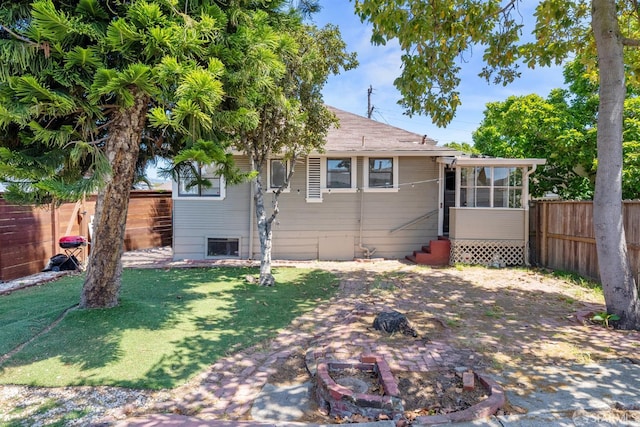 2875 Sunset Ave, Oakland, CA 94601 - rear view of house featuring a sunroom