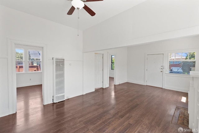 2875 Sunset Ave, Oakland, CA 94601 - unfurnished living room featuring a heating unit, a ceiling fan, dark wood-type flooring, and a high ceiling