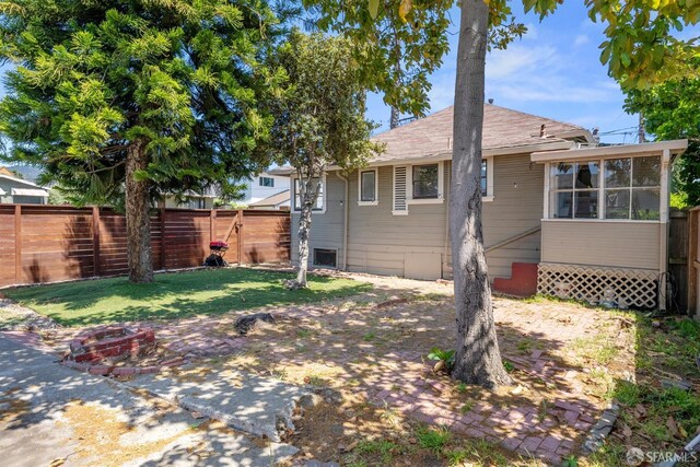 2875 Sunset Ave, Oakland, CA 94601 - rear view of property featuring a fenced backyard and a sunroom