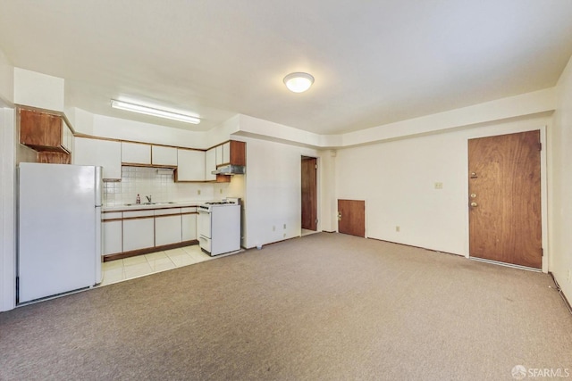 kitchen featuring white cabinetry, sink, backsplash, light colored carpet, and white appliances