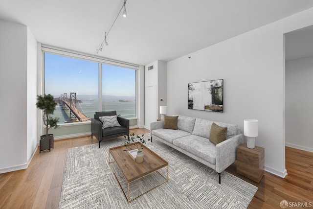 425 1st St Unit 3301, San Francisco, CA 94105 - living room with track lighting, wood finished floors, and a water view