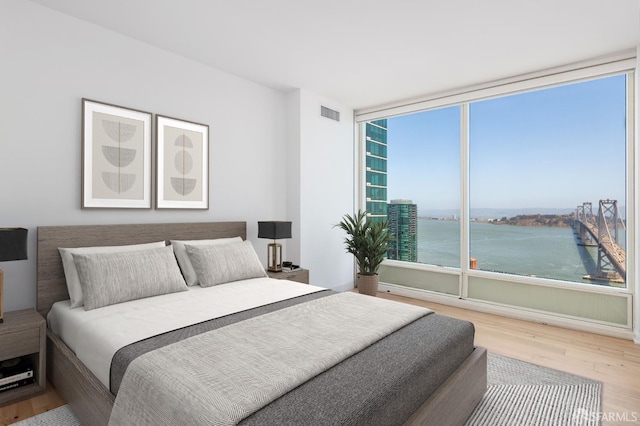 425 1st St Unit 3301, San Francisco, CA 94105 - bedroom featuring wood finished floors and a water view