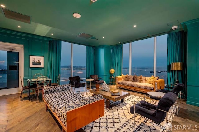 425 1st St Unit 3301, San Francisco, CA 94105 - living room with floor to ceiling windows, wood finished floors, a water view, a decorative wall, and recessed lighting