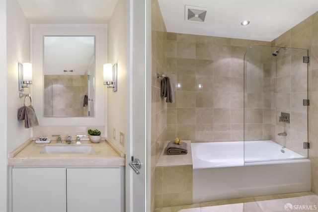 bathroom featuring vanity, enclosed tub / shower combo, and tile patterned floors