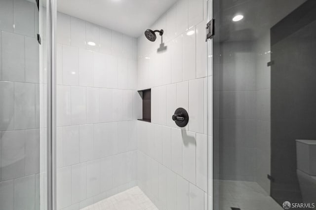 bathroom featuring a shower with door