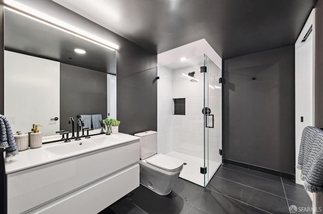 bathroom with a shower with shower door, vanity, tile patterned floors, and toilet