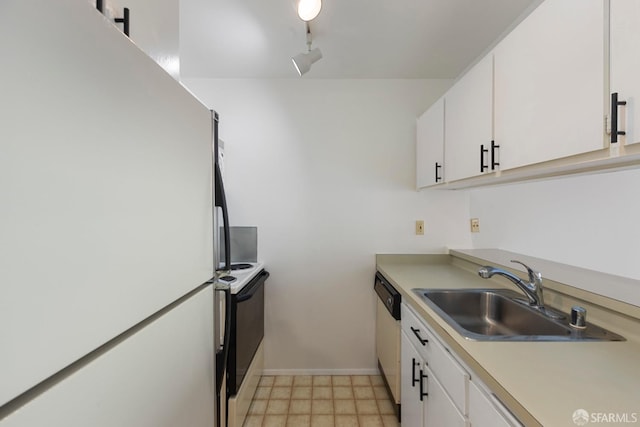 kitchen featuring light countertops, white appliances, a sink, and white cabinetry