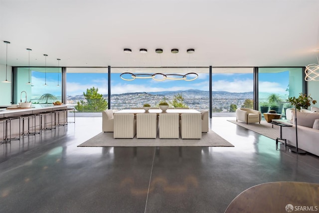 living area featuring expansive windows and a mountain view