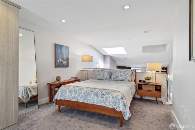 carpeted bedroom featuring lofted ceiling with skylight