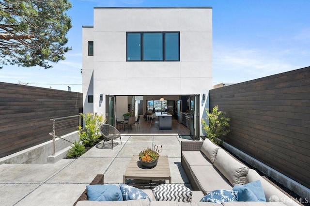 rear view of property featuring an outdoor hangout area and a patio