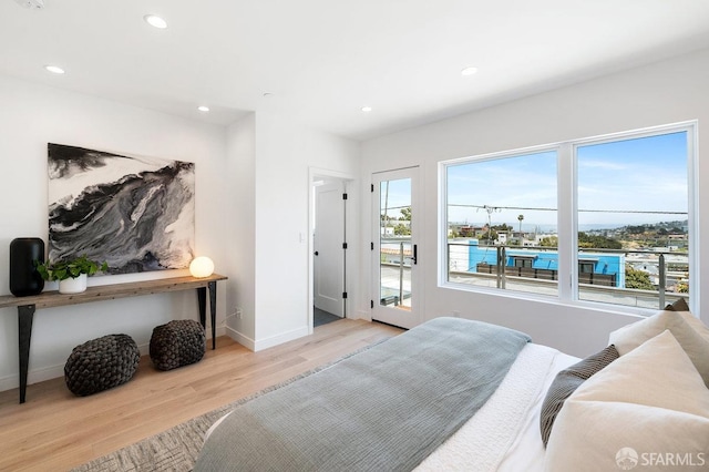 bedroom featuring light hardwood / wood-style flooring and access to exterior